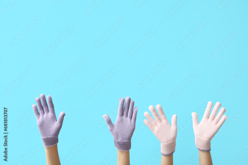 Female hands in warm gloves on color background Female hands in warm gloves on color background