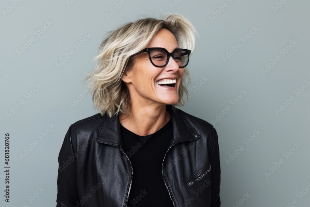 Portrait of a happy mature woman in black leather jacket and glasses Portrait of a happy mature woman in black leather jacket and glasses