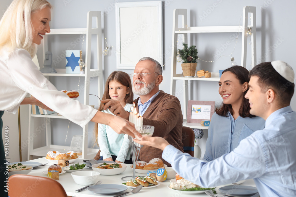 Happy little girl having dinner with her family at home on Hanukkah Happy little girl having dinner with her family at home on Hanukkah