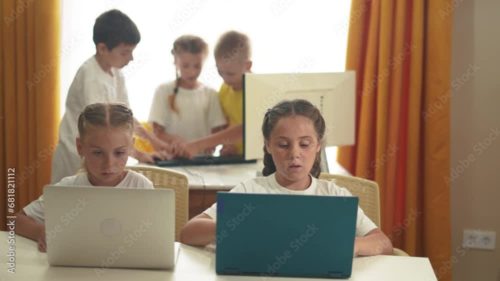 children learn from home through computers. business concept of modern training and development. a group of small kids perform tasks in a laptop at home schooling. educating lifestyle at home children learn from home through computers. business concept of modern training and development. a group of small kids perform tasks in a laptop at home schooling. educating lifestyle at home
