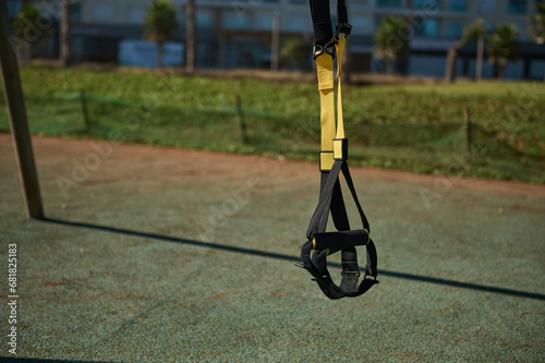 Suspension straps hanging on crossbars on outdoors sportsground
