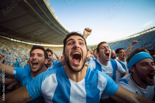 Latin american football fans from Argentina celebrating a goal inside a stadium photo
