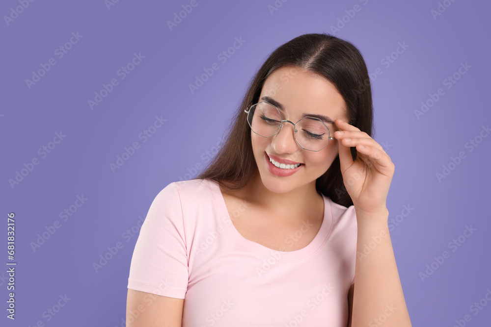 Beautiful woman wearing glasses on violet background. Space for text Beautiful woman wearing glasses on violet background. Space for text