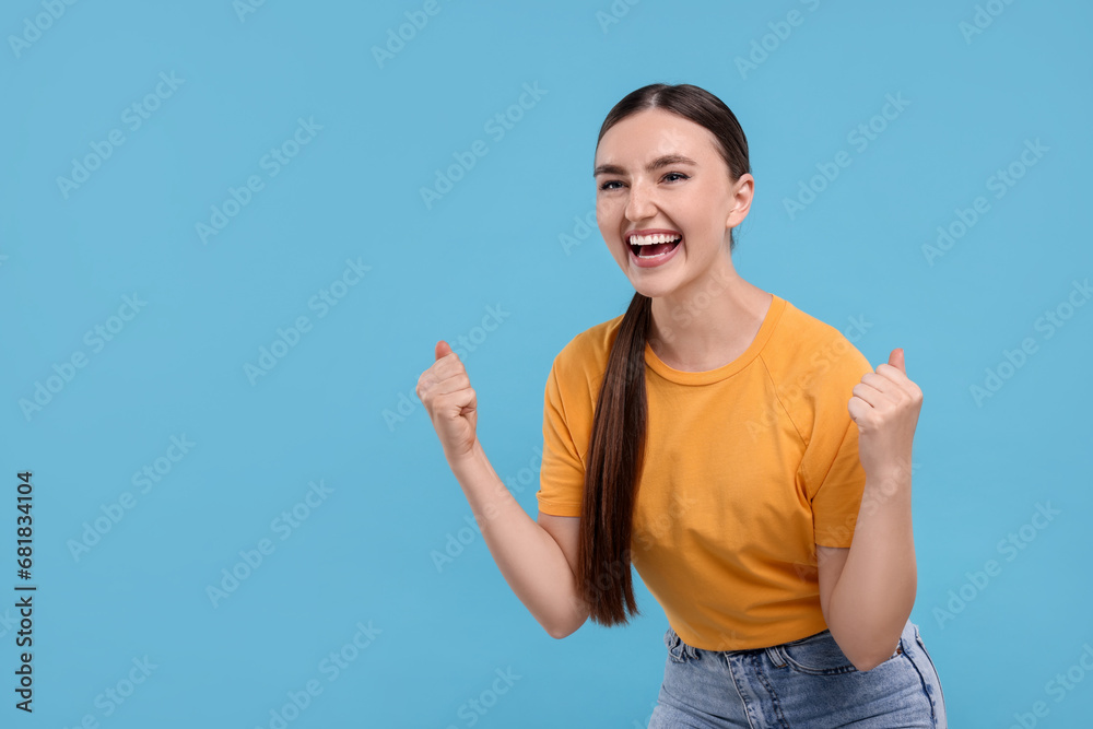 Happy sports fan celebrating on light blue background. Space for text Happy sports fan celebrating on light blue background. Space for text