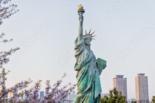 Canvas Print Statue of Liberty next to a blooming cherry tree in Tokyo, Japan