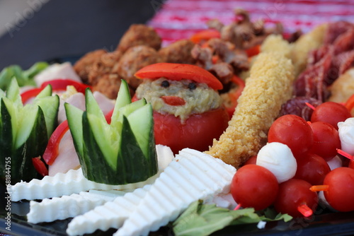 A tantalizing close-up of a vibrant plate, adorned with fresh cucumber slices and juicy tomato wedges, ready to be savored. photo