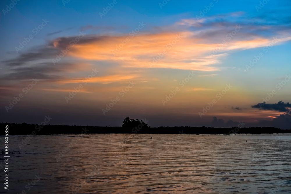 orange clouds at sunrise over the lake