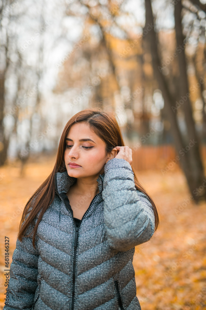 Beautiful indian woman generation z relaxing and feeling nature at autumn park in fall season copy space. Diversity and gen z youth Beautiful indian woman generation z relaxing and feeling nature at autumn park in fall season copy space. Diversity and gen z youth