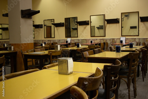 old restaurant room with empty chairs and tables