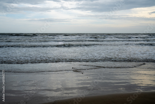 Soft wave of blue ocean on sandy beach. Background.