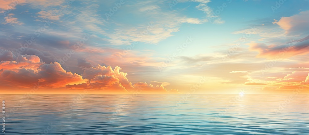 As the summer sun sets over the tranquil sea, the sky transforms into a breathtaking blend of orange, blue and white colors, reflecting off the calm waters, creating a truly mesmerizing landscape of