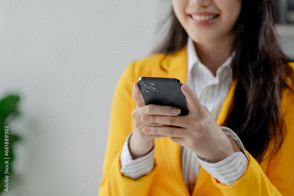 Businesswoman is working in the office and talking on the phone with a partner, Entrepreneurs use smartphones to find information in order to present it, Working in a private office at a company. Businesswoman is working in the office and talking on the phone with a partner, Entrepreneurs use smartphones to find information in order to present it, Working in a private office at a company.