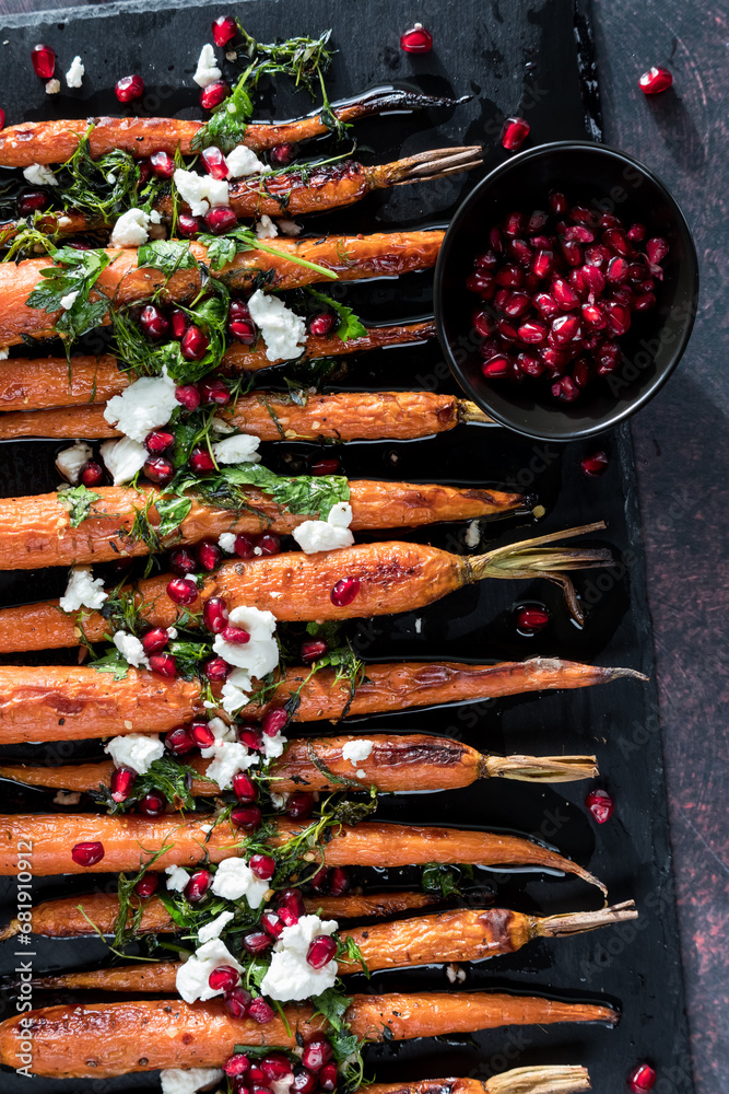 Roasted carrots topped with cheese, herbs and pomegranate arils.