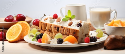 Puja prepared a healthy and colorful breakfast that consisted of a white fruit cake, made with coconut and chocolate, placed on a table isolated in a white background, to celebrate the festival while