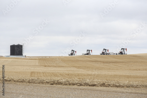 oil well pumps on a prairie farm field