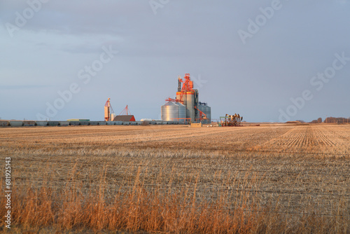 Silver steel grain terminal at dusk on the prairie