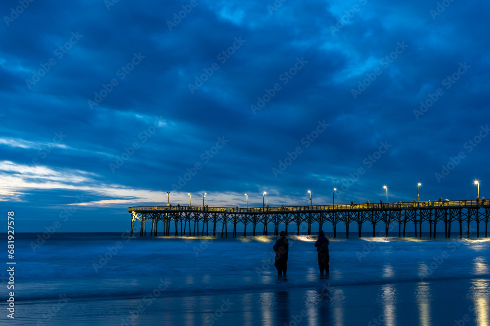 Ocean Pier with Stormy Cloud Background before Sunrise