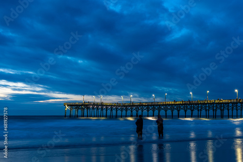 Ocean Pier with Stormy Cloud Background before Sunrise