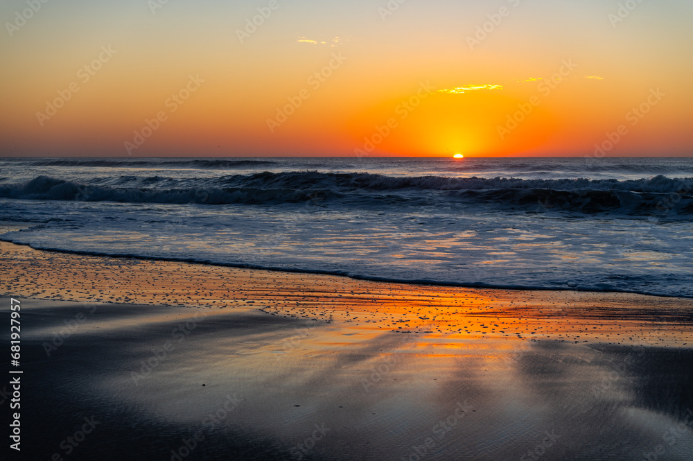 Beach Sunrise (sun on right) with reflecting wet sand