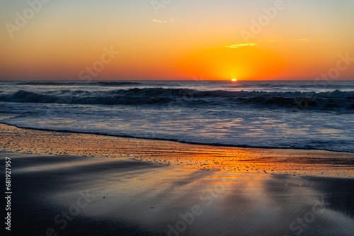 Beach Sunrise  sun on right  with reflecting wet sand