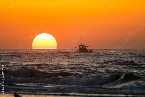 Sunrise with Fishing Boat on Horizon