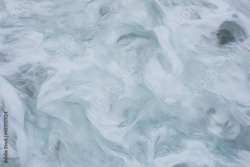 Churning frothy sea captured in a soft-focus, ideal for natural aquatic themes or tranquil spa-like settings.