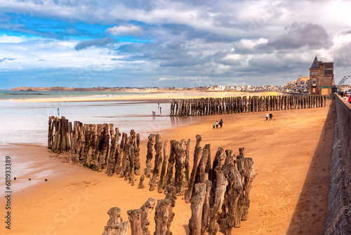 Wooden breakwater and beach at low tide, in walled port city of Saint-Malo, Brittany, France