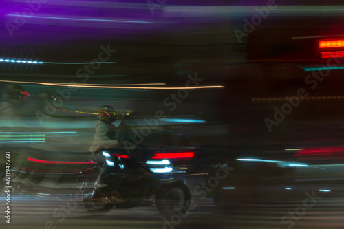 portrait shot of motorcycle moving through traffic