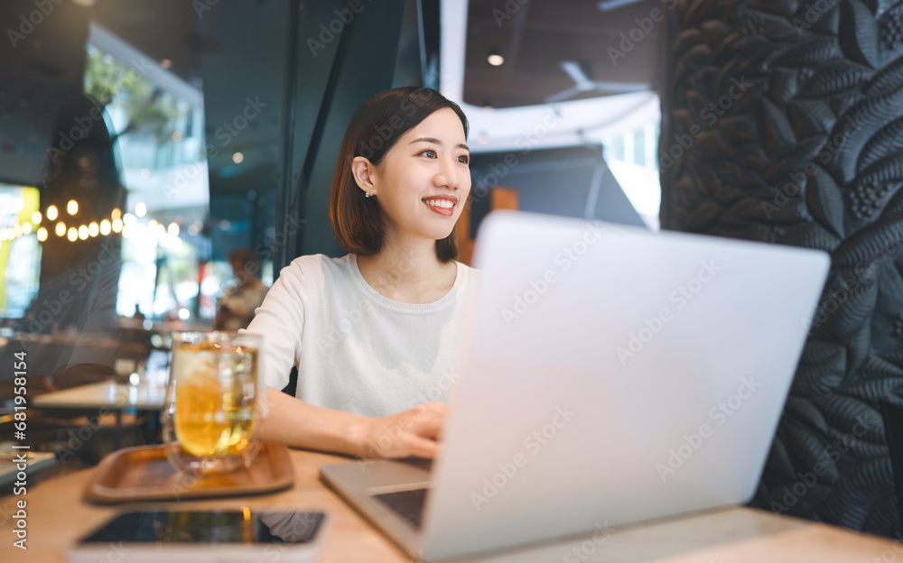 Asian woman using laptop and waiting at coffee cafe city break weekend balance lifestyle
