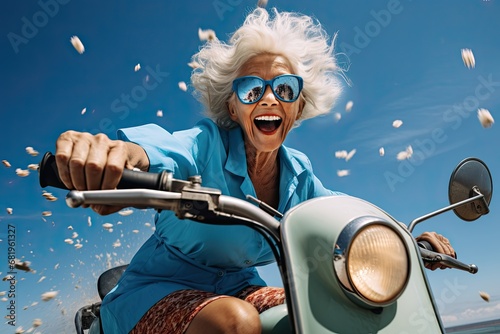 An elderly cheerful woman with gray hair rides a blue scooter and smiles. Generated by AI. photo