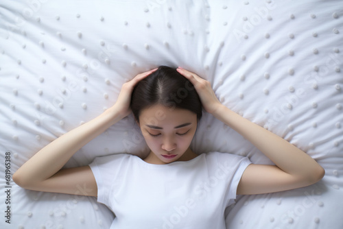 Asian woman resting on the bed