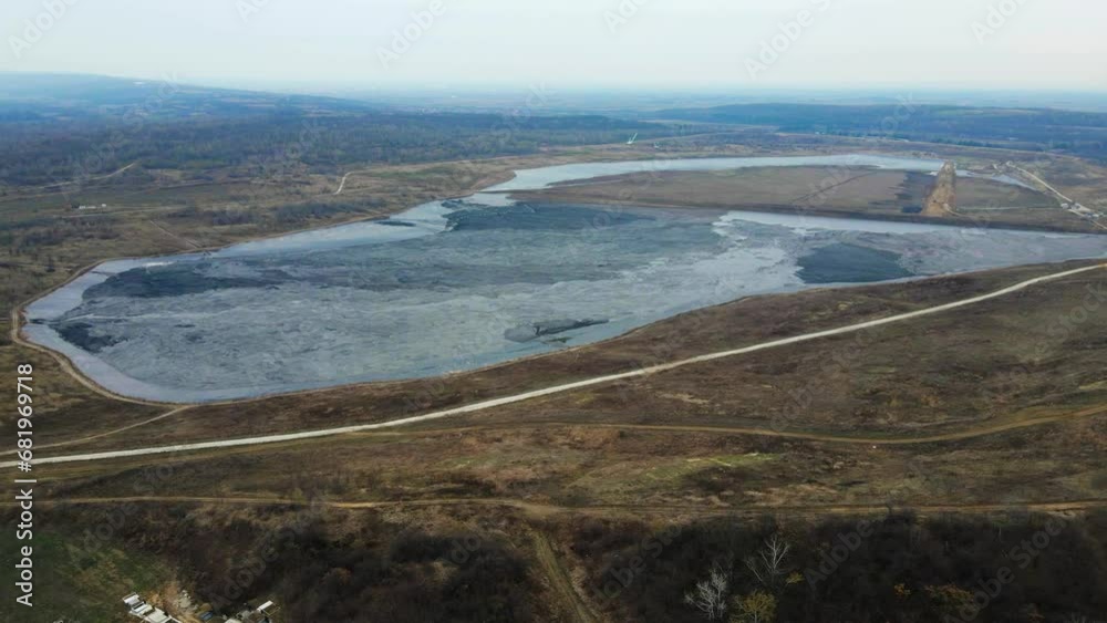 Aerial view of large frozen lake surrounded by fields and woods Aerial view of large frozen lake surrounded by fields and woods