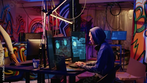 Teamworking hackers in graffiti sprayed hideaway targeting vulnerable unpatched connections, having burst of joy after getting past digital devices security and stealing valuable sensitive data photo