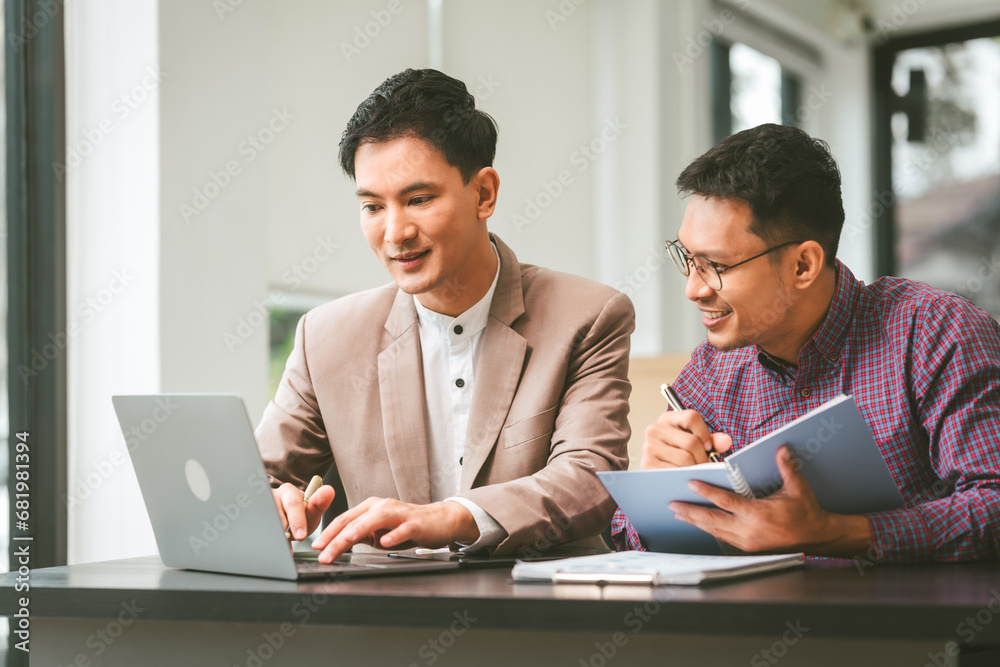 Two professionals in meeting, one presenting Two professionals in meeting, one presenting