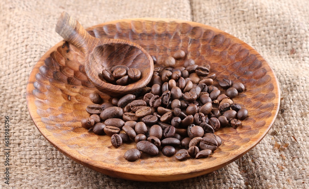 Fototapeta premium A coffee bean is a fruit from the Coffea plant and the source for coffee. It is the pip inside the red or purple fruit. 