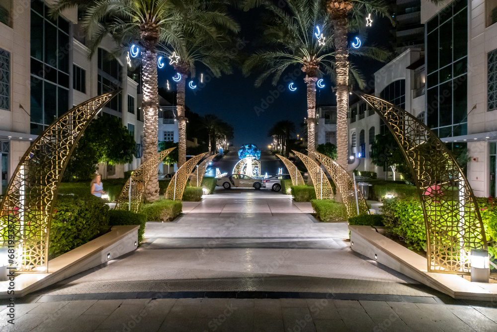 Night view to decorative illuminated pedestrian alley at Dubai Marina in Dubai city, United Arab Emirates