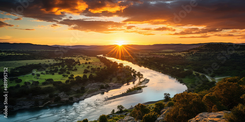 First light of sunrise over a river, seen from a hill's vantage point