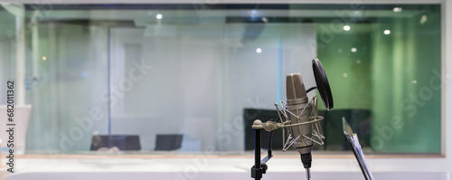 Studio microphone and pop shield on mic in the empty recording studio. Professional microphone close up in recording studio. Microphone in a recording studio