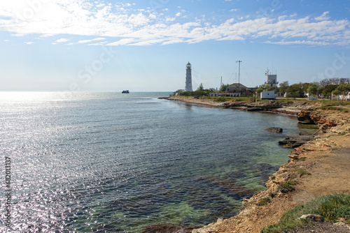 Lighthouse on Cape Tarkhankut. The rocky coast of the Dzhangul Reserve in the Crimea. Turquoise sea water. Tarkhankutsky lighthouse on the Crimean peninsula. photo