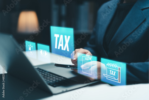 Businesswoman using the laptop to fill in the income tax online return form for payment. Financial research,government taxes and calculation tax return concept. Tax and Vat concept