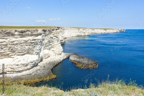 Cape Tarkhankut on the Crimean peninsula. The rocky coast of the Dzhangul Reserve in the Crimea. The Black Sea. Turquoise sea water. Rocks and grottoes of Cape Tarkhankut. photo