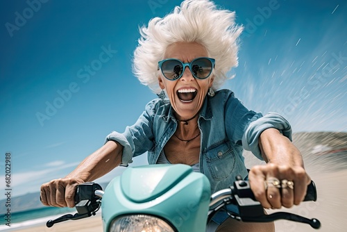 An elderly cheerful woman with gray hair rides a blue scooter and smiles. Generated by AI. © index74