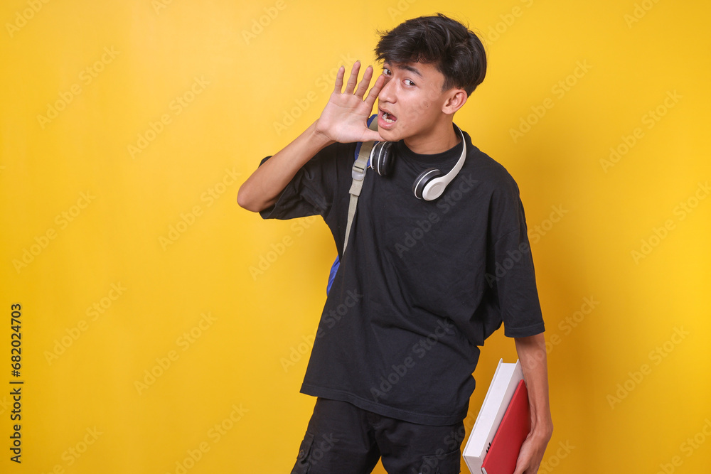 Young Asian student man screaming aside, making announcement Young Asian student man screaming aside, making announcement