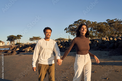 Interracial Couple at The Beach Together in Love Enjoying Each Other Company 
