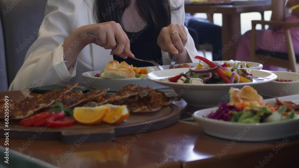 People sit at a table in a restaurant and eat People sit at a table in a restaurant and eat