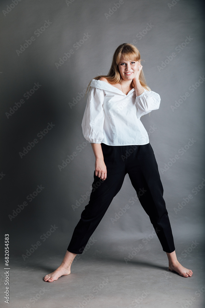 Beautiful young woman in white blouse and black pants Beautiful young woman in white blouse and black pants
