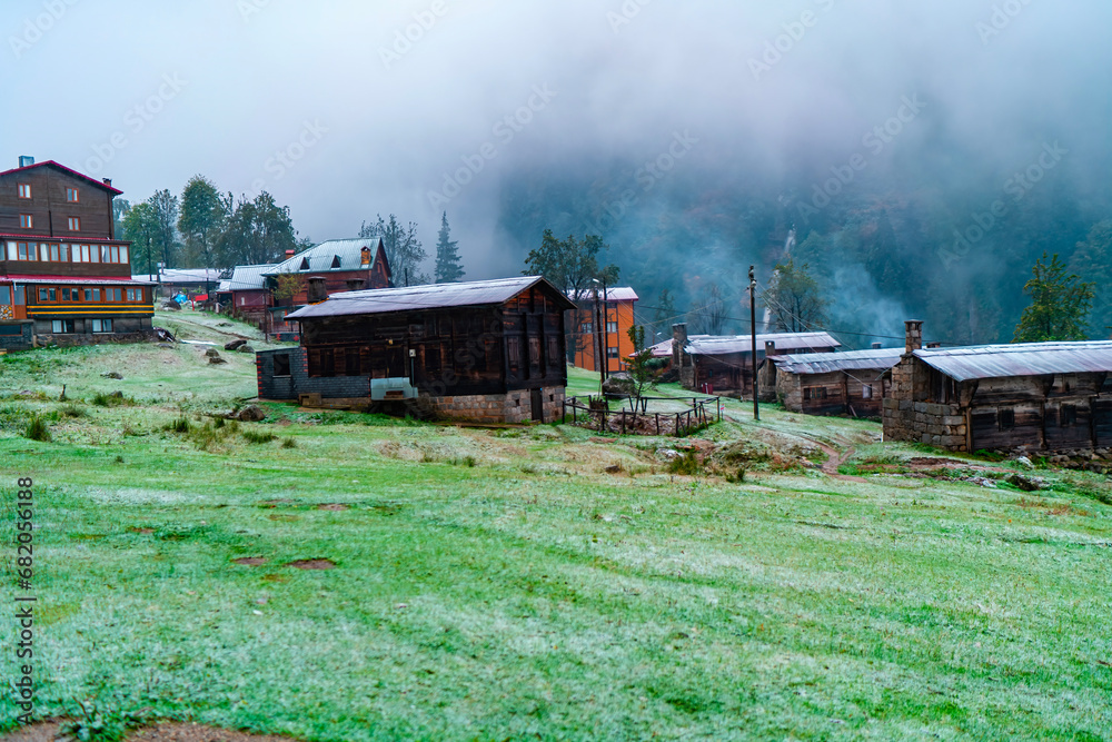 Obraz premium Wooden plateau house integrated with green nature. Plateau houses are made of stone and wood. Wooden plateau houses built on a hill.