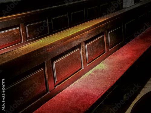 Parts of pews with red seat cashion photo