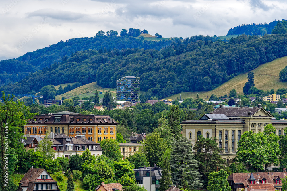 Obraz premium Scenic view of mountain panorama and woodland with local mountain Gurten seen from the old town of City of Bern on a cloudy summer day. Photo taken July 1st, 2023, Bern, Switzerland.