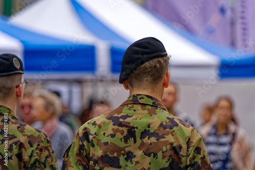 Swiss Army soldiers at town square of Federal Palace on a cloudy summer day. Photo taken July 1st, 2023, Bern, Switzerland.